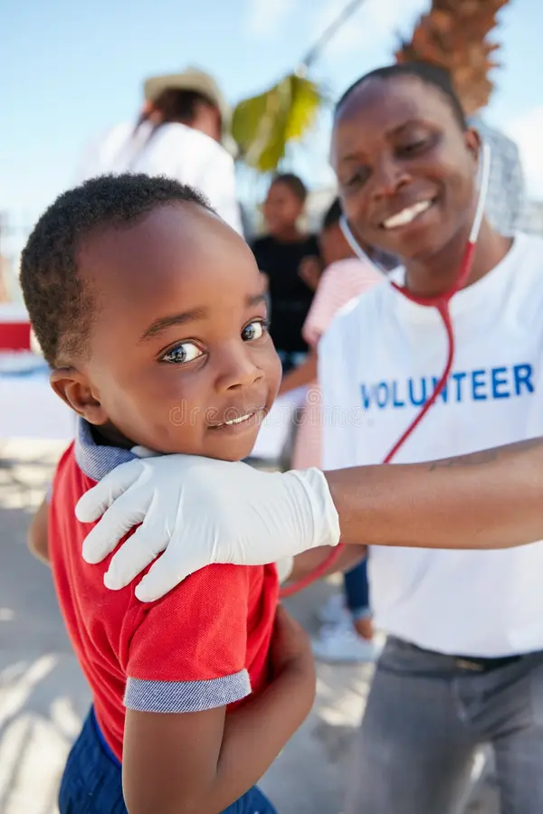 services-04 happiness starts good health volunteer doctor examining young patient stethoscope charity event happiness 265160219